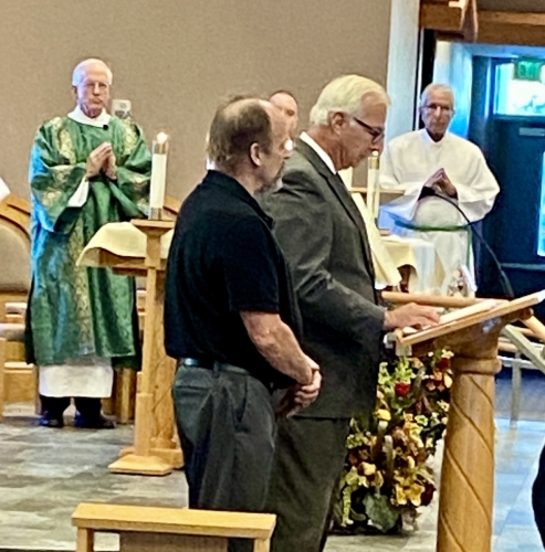 Paul Ceciliani and Jeff Maschler read the list of dearly departed